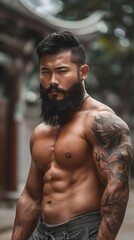 Asian man with tattoos and beard.