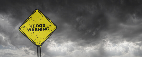 flood warning sign on cloudy sky background