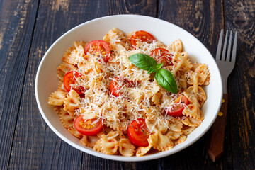 Farfalle pasta with tomatoes and cheese. Healthy eating. Vegetarian food.