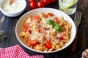 Farfalle pasta with tomatoes and cheese. Healthy eating. Vegetarian food.