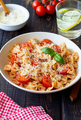 Farfalle pasta with tomatoes and cheese. Healthy eating. Vegetarian food.