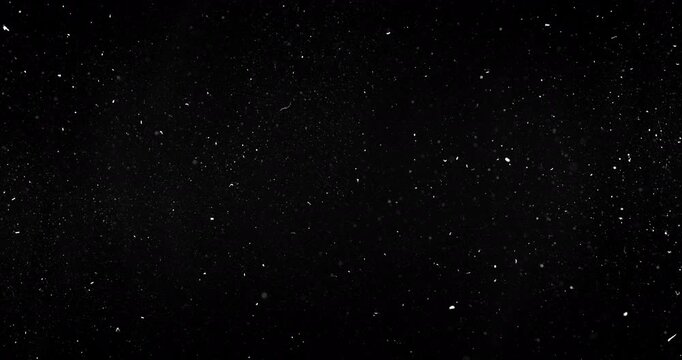 Dust particles dynamically moving on black background. Dense dynamic particles floating around.