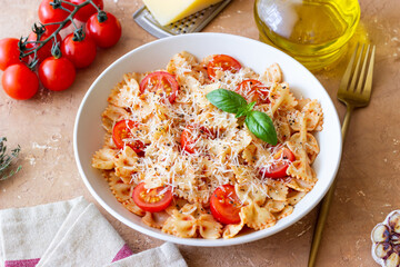 Farfalle pasta with tomatoes and cheese. Healthy eating. Vegetarian food.