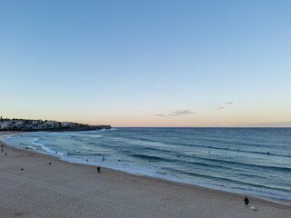 Silhouettes people beach walking surfing sunset calm waves relaxing