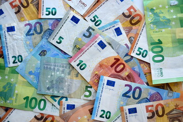 Many european euro money bills in chaotic arrangement. Pile of eur banknotes with different colors and condition