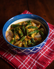 Dahi Bhindi or Okra made with yogurt and Indian spices served in a bowl. Close up, selective focus.