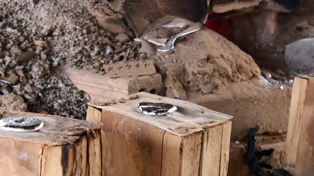 Ban Napia, Laos - 15th january, 2024: laotian people make aluminum spoons from Vietnam war era munition remains or UXO. Collect UXO , melt down in kiln and fashion it to spoons household items