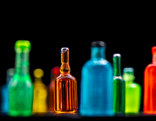 various miniature bottles of alcohol without labels with black bacground