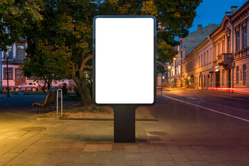Mockup Of An Outdoor Poster Billboard On Street At Night. Blank Advertising Display With Car Light Trails In The Background