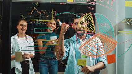 Happy smart businessman celebrate successful project at glass wall while explain marketing strategy to business people. Professional male leader show financial statistic at glass wall. Tracery