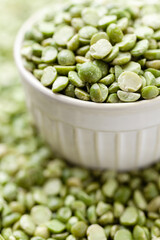 Uncooked, green peas in bowl. Split peas grains