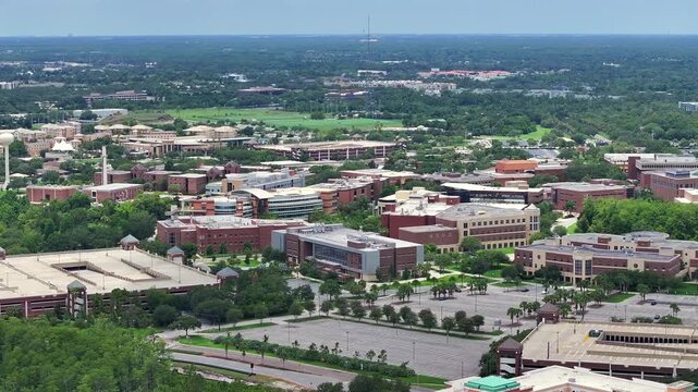 Drone view of the University of Central Florida campus with parking structures and academic buildings. Aerial perspective in Orlando, Florida.
