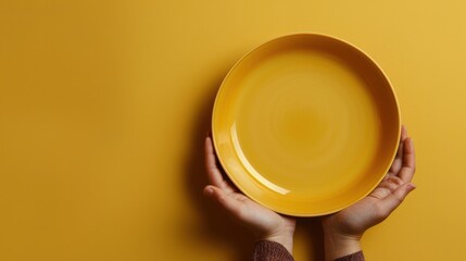 World Hunger day. Empty plate in hands on a yellow background. Horizontal banner. Free space for text. Promoting Global Food Security, Fighting Hunger, food availability