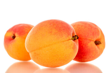 Three ripe apricots, macro, isolated on white background.