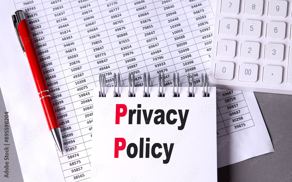 Poster privacy policy text on notebook with chart , pen and calculator