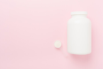 Jars with protein powder on color background, top view. Sports nutrition concept