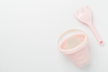 Cute toys for playing with sand on color background, top view