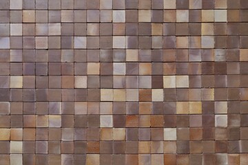 Vintage square earthenware tiles with shaded colors among dark brown and pale yellow. Background and texture. Full frame.