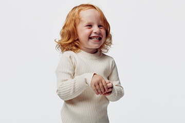 Happy little girl in white turtleneck sweater laughing, beauty and joy in childhood happiness, innocent laughter on winter day