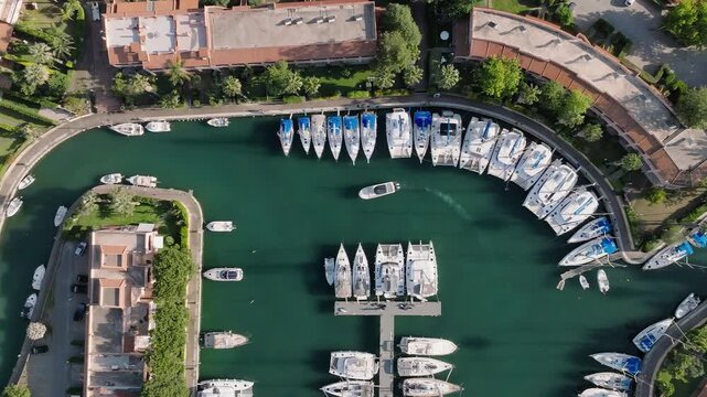 4K Aerial of Portorosa Marina, Sicily. Static shot top down of speed boad going to moor