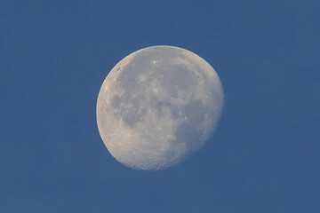 Full moon over blue sky