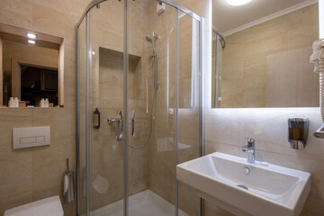 Interior of a hotel bathroom with glass bathroom