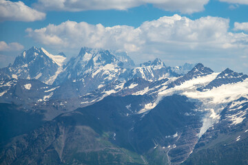 Mountain landscape against a blue sky with clouds