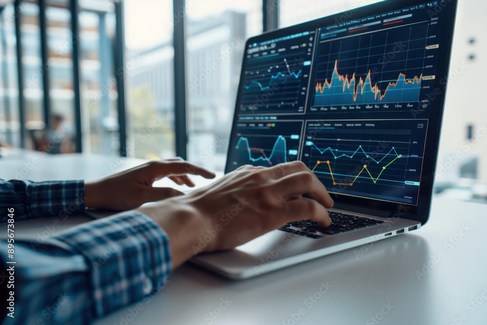 Poster businessman is using a laptop and analyzing financial data displayed on a screen with charts and gra