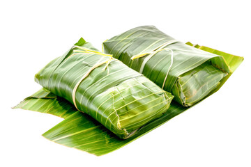 Two Bambangan, tied with string, rest upon a bed of green banana leaves