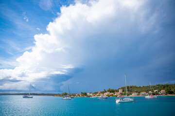 Yachts moored on buoys near the shore in the bay of Uvala Gradina near the town of Vela Luka on the island of Korcula in Croatia