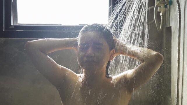 A woman taking a shower at home. People lifestyle.