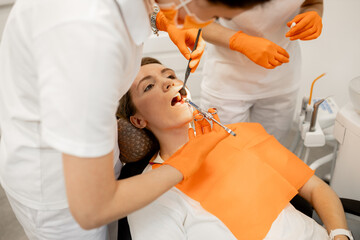 The dentist injects the patient's tooth gum using a syringe. Modern medical equipment. Oral treatment concept. Close-up.