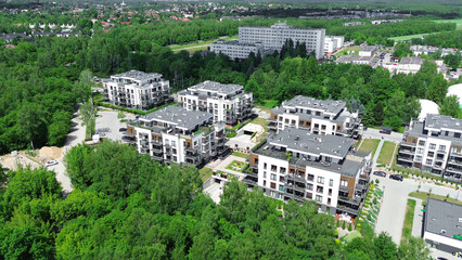 Fototapeta premium Aerial shot of modern residential buildings and green landscape