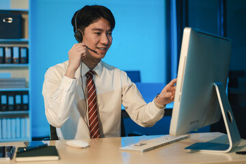 Customer call center service executive working at the office, employees working overtime.