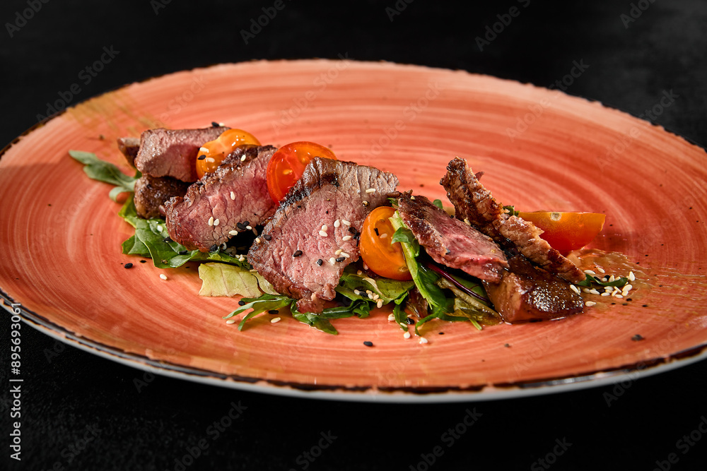 Wall mural gourmet roast beef with tomatoes and arugula on a rustic plate