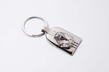 Chrome key chain or key ring with mask of King Tutankhamun, the Egyptian pharaoh, on white...