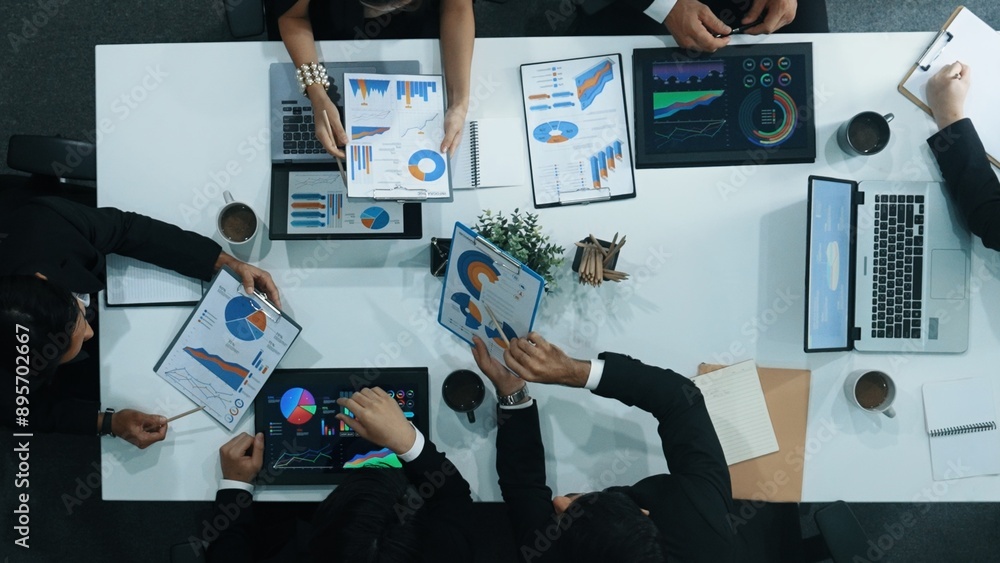 Poster top down aerial view of business people discussing about financial strategy on table with document a