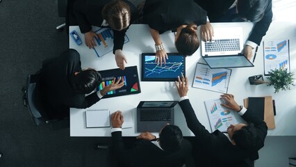 Top view of smart business people brainstorm marketing idea at meeting table while compare stock...