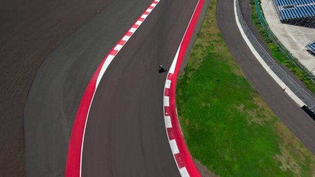 Motorcyclists ride along a race track. Motorcyclists are training. drone fpv