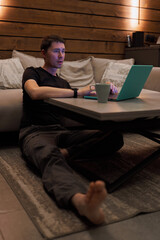 Man Working on Laptop with Coffee in Cozy Home