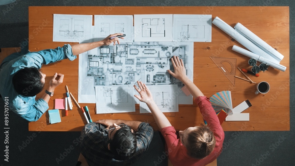 Poster group of people looking at blueprint while brainstorming idea. top view of engineer team looking and