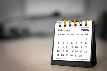 Calendar page February of the year 2025 white color in meeting room in office. with copy space and...