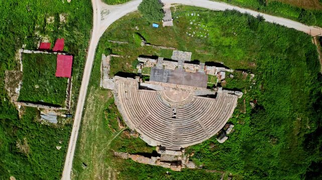 Top down aerial drone shot of the Theatre of Dodona in the Epirus region in Greece. Drone view over ancient historical greek amphitheater. Archaeological site.