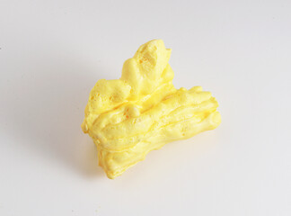 Solid sulfur or sulphur, one of chemical elements in lemon yellow, from Ijen crater in East Java, Indonesia. When burned, it melts into a blood-red liquid and emits a blue flame. Isolated on white.