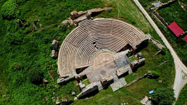 Top down aerial drone shot of the Theatre of Dodona in the Epirus region in Greece. Drone view over ancient historical greek amphitheater. Archaeological site.