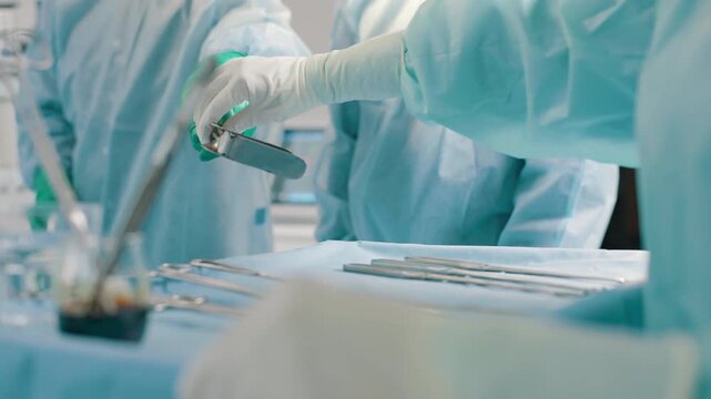 Surgeons prepare instruments in operating room