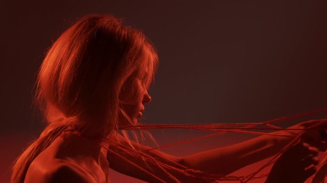 Young man and woman lovers shot, passion intimacy foreplay, couple tied tangled bodies with thread, affective expression. Love affection relationships concept.