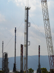 Refinery Under Construction with Heavy Machinery and Building Materials