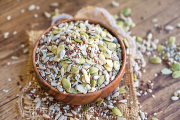 Sunflower and pumpkin seeds in wooden bowl . Salad mix with seeds 