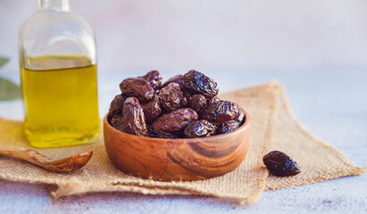 Olives kalamata in wooden bowl and olive oil